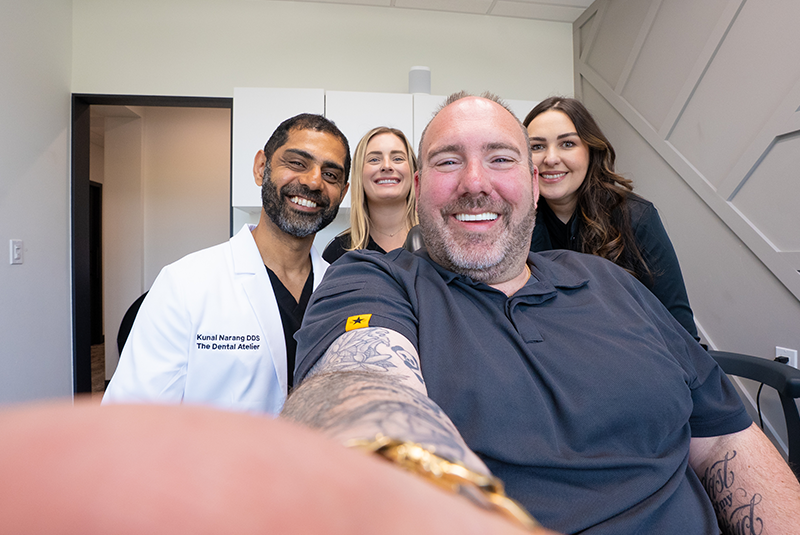 patient, Dr. Narang and two staff members smiling with the patient who is doing a selfie